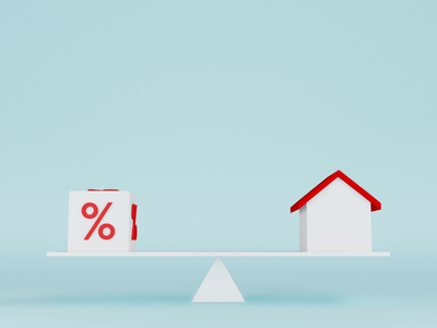 Seesaw graphic showing a house and an interest icon, illustrating how mortgage interest affects monthly payments.